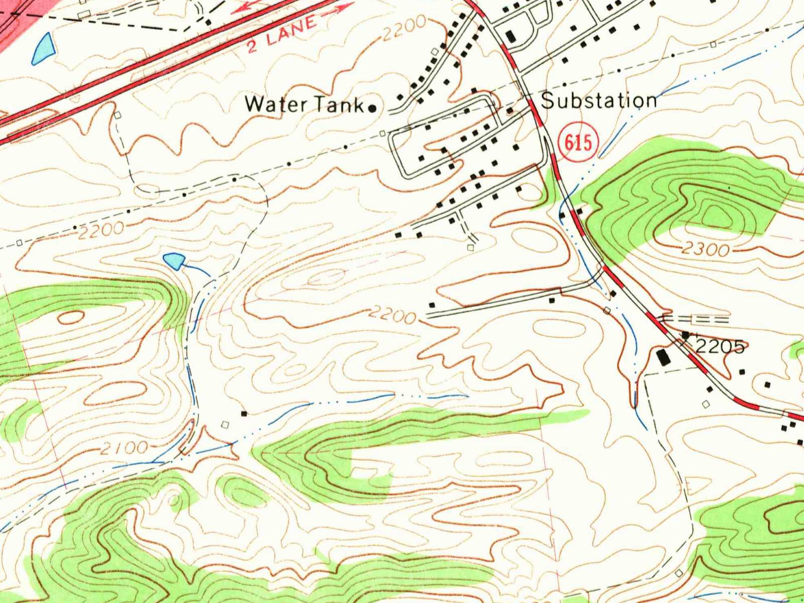 Detail of a 1965 topographic map: a red road with a 615 route sign running down the right side, a single street branching west from it along a ridge with a few black house squares, a water tank and a substation labeled to the north, a divided highway across the upper left, and green woods on the hills to the south.