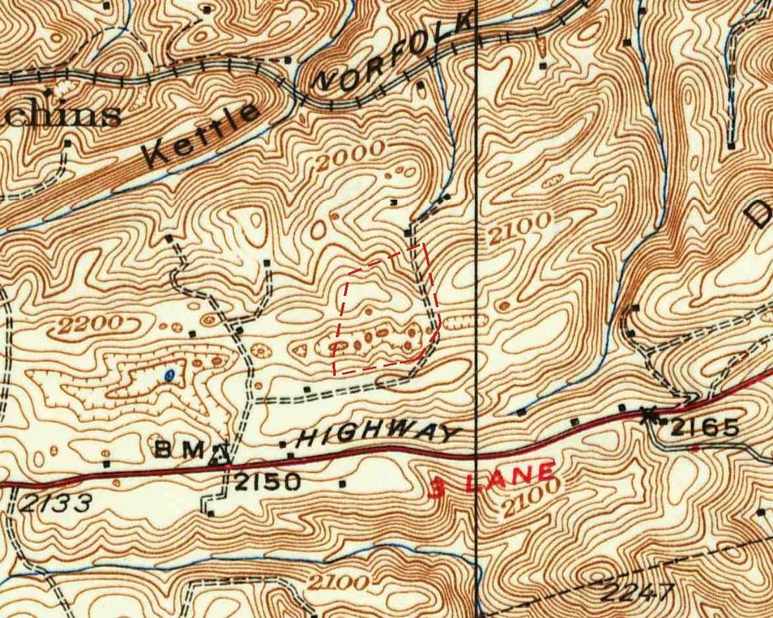Detail of a 1937 topographic map in brown contour lines: a railroad labeled Norfolk at top, the word Kettle along a ridge, many small closed contour rings with hatch marks, a dashed red outline around a row of them, and a highway labeled Highway and 3 Lane along the bottom.